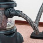 Carpet - Black and Red Canister Vacuum Cleaner on Floor