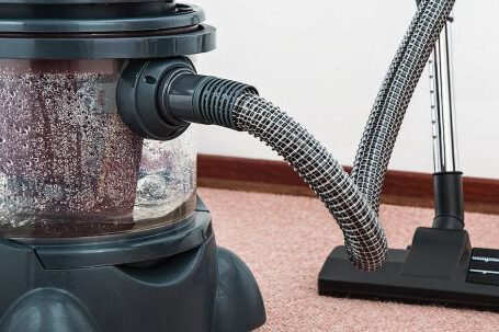 Carpet - Black and Red Canister Vacuum Cleaner on Floor