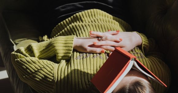 Sofa - Woman in Green Sweater Holding Red Book