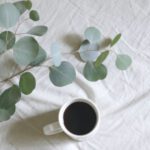 Table Linens - Flat Lay Photography of White Mug Beside Green Leafed Plants