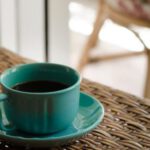 Coffee Table - Blue Coffee Cup With Saucer Filled With Coffee on Top of Wicker Table