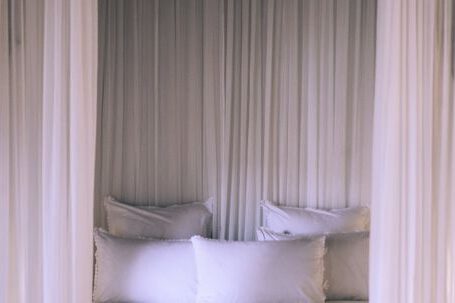 Bed - Cozy bed under white translucent canopy