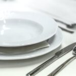 Cutlery - Round White Ceramic Bowl Placed on Table Beside Wine Glass