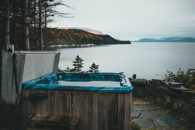 a-hot-tub-sitting-next-to-a-body-of-water